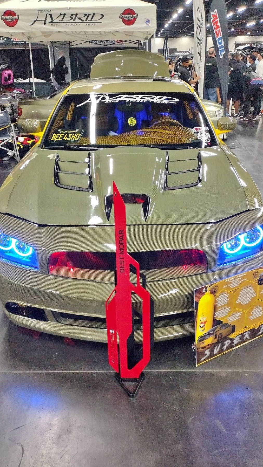 The Super Bee nose-on in olive carbon Kevlar with a Best Mopar trophy in front of it